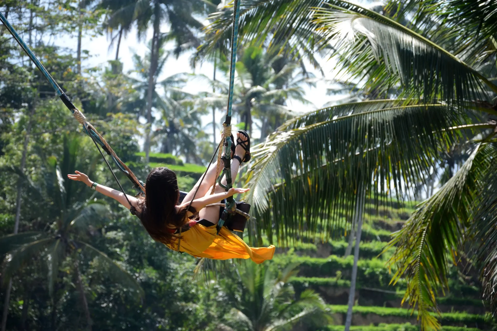 young-woman-swinging-jungle-rainforest-bali-indonesia
